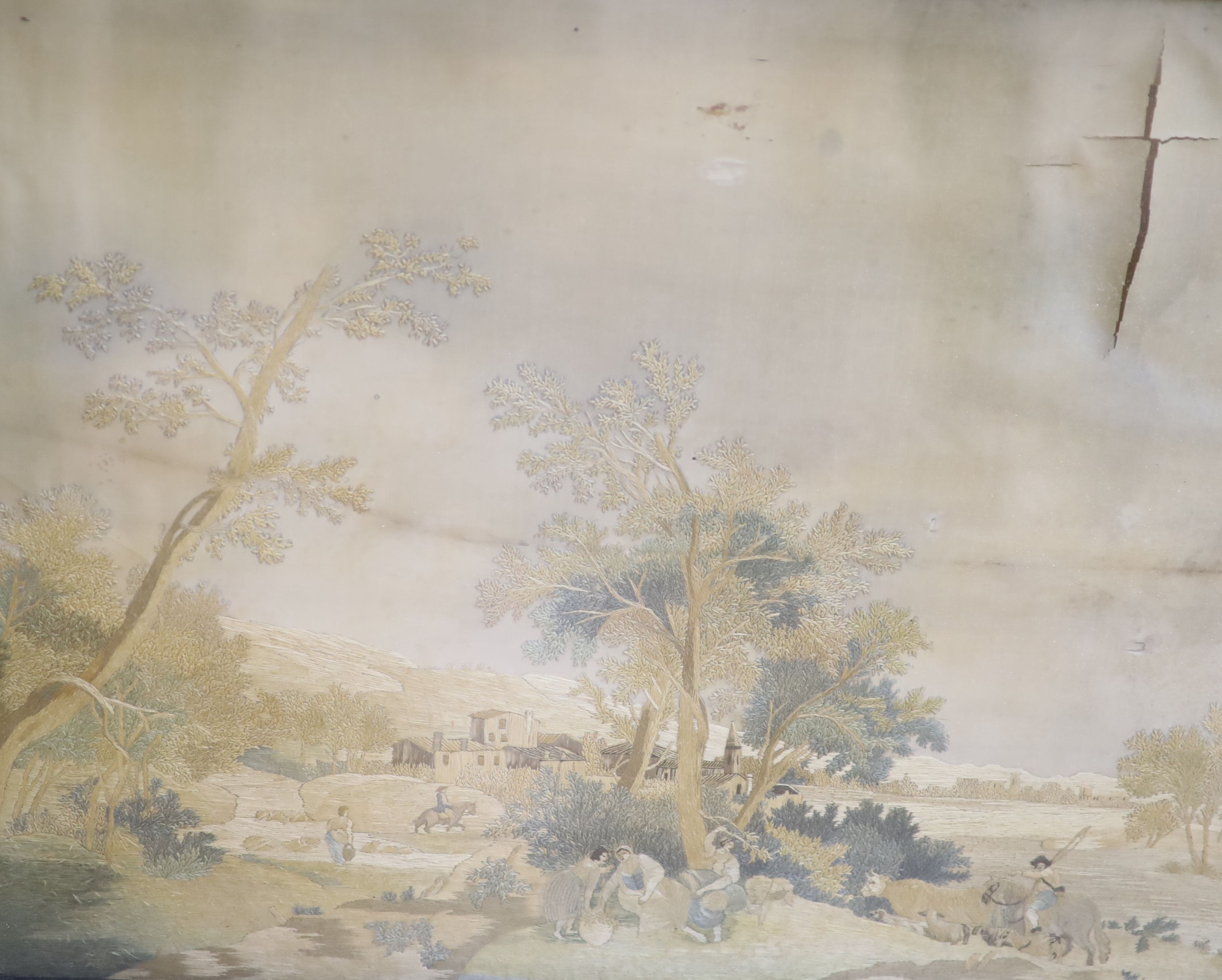 A pair of early 19th century silkwork panels depicting landscapes, 37 x 47cm, framed